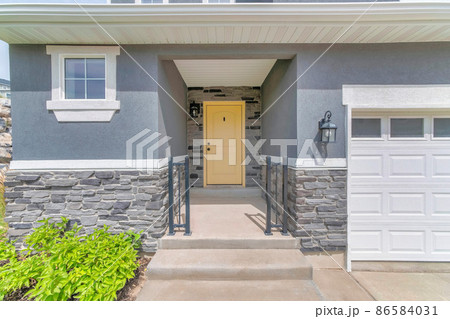 Facade of a house with gray wall sidings and garage Facade of a house with gray wall sidings and garage 86584031