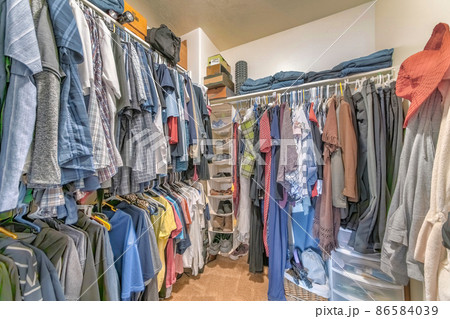 Walk-in closet with hanging linen shoe rack and clothes Walk-in closet with hanging linen shoe rack and clothes 86584039
