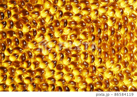 The texture of the capsules in the shell with liquid vitamin D3 in full screen. 86584119