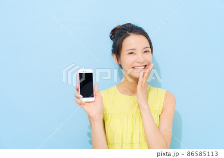 スマホ　20代女性　水色背景 86585113