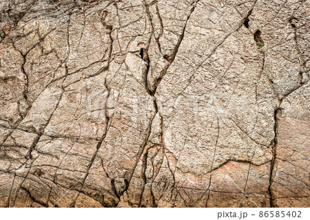 Dry gray cracked surface of stone ground 86585402