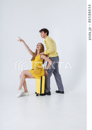 Beautiful young couple travelers having fun in studio 86586634