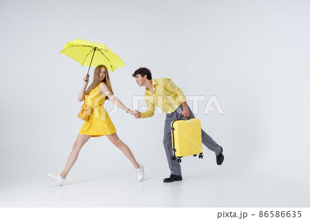 Happy couple travelers walking hand in hand in studio 86586635