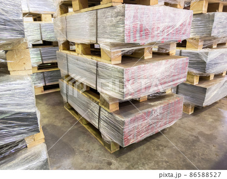abstract industrial palleted production stacks indoors on the floor 86588527