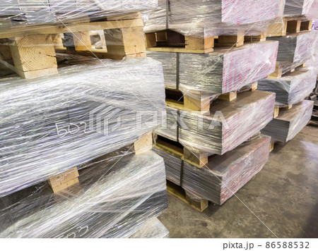 abstract industrial palleted production stacks indoors on the floor 86588532