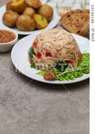 Delicious chicken aspic on a plate on concrete table 86590165