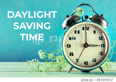 Daylight Saving Time concept, spring forward. A vintage alarm clock Daylight Saving Time concept, spring forward. A vintage alarm clock 86594042