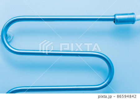 Metal cold towel dryer in the bathroom on the wall hot pipe at home Metal cold towel dryer in the bathroom on the wall hot pipe at home 86594842