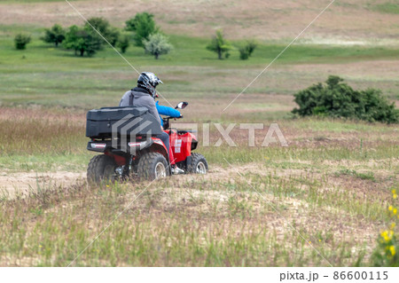People Riding Quadbikes in spring off-road fields People Riding Quadbikes in spring off-road fields 86600115