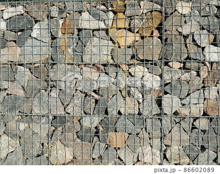 Gabion, a modular containment system made from wire mesh and filled with stones Gabion, a modular containment system made from wire mesh and filled with stones 86602089