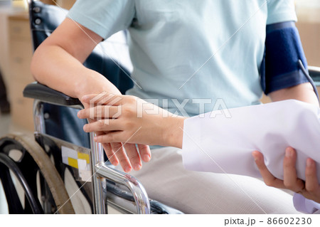 Closeup hands of doctor woman encourage patient senior sitting wheelchair at the hospital. Closeup hands of doctor woman encourage patient senior sitting wheelchair at the hospital. 86602230