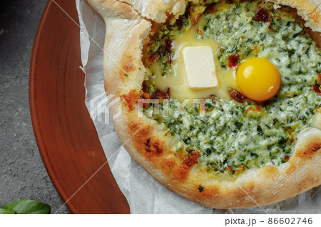 Some khachapuri traditional Georgian homemade cheese and spinach pies on the plate Some khachapuri traditional Georgian homemade cheese and spinach pies on the plate 86602746