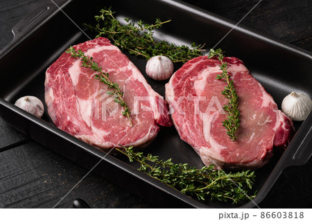 Classic fresh rib eye steak, on black wooden table background Classic fresh rib eye steak, on black wooden table background 86603818