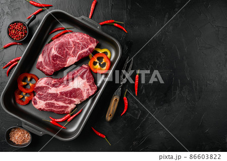 Chuck eye roll beef meat steak, on black dark stone table background, top view flat lay, with copy space for text Chuck eye roll beef meat steak, on black dark stone table background, top view flat lay, with copy space for text 86603822