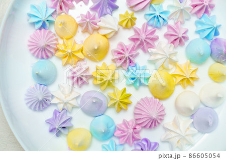 Closeup of delicious colorful meringue cookies on plate. Sweet decor. Confectionery  86605054