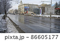 Cars are driving along Bolshaya Sadovaya Street, pedestrians are walking in winter after a snowfall 86605177