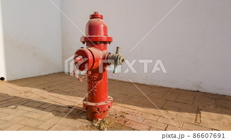 Red fire hydrant on a city street 86607691