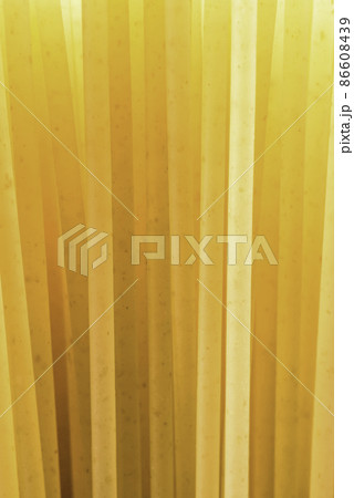 beam of yellow pasta straws on the light beam of yellow pasta straws on the light 86608439