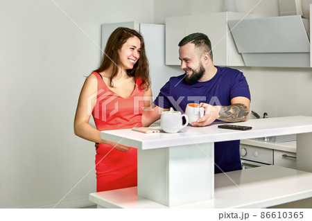 Flirl in office kitchen between cheerful employees. 86610365