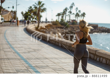 Young athlete female having workout session outdoors Young athlete female having workout session outdoors 86611499