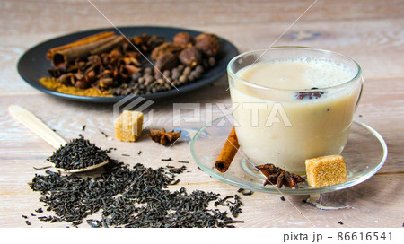 Traditional indian or Asian drink masala tea with spices and sugar in glass cup. 86616541