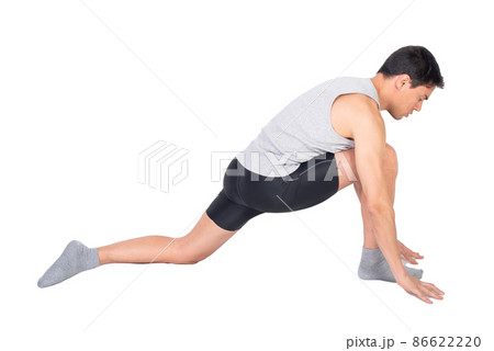 Determined sportsman stretching psoas muscle in studio 86622220