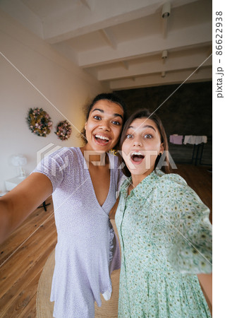 Two girls take selfies in the living room 86622938