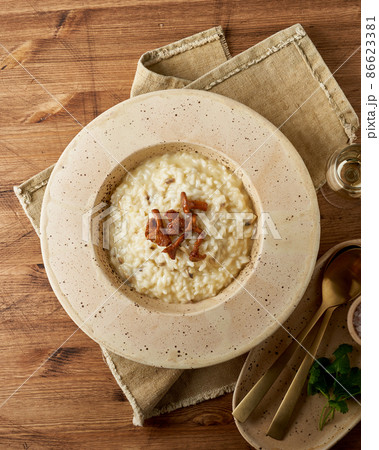 Risoto with chanterelle mushrooms in large plate. Traditional italian dish. Wooden old table Risoto with chanterelle mushrooms in large plate. Traditional italian dish. Wooden old table 86623381
