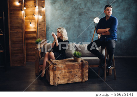 elegant couple posing ay gray decorated studio. 86625141
