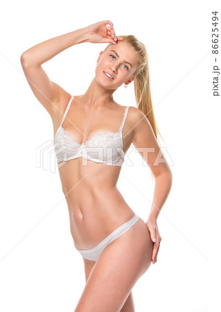 Young blonde woman in white underwear, studio Young blonde woman in white underwear, studio 86625494
