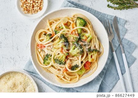 Spaghetti pasta with broccoli, bucatini with peppers, garlic, pine nuts. Food for vegans 86627449
