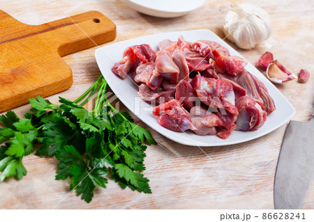 Raw chicken gizzards on wooden table Raw chicken gizzards on wooden table 86628241