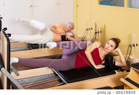 Active women perform a stretching exercise Active women perform a stretching exercise 86628809