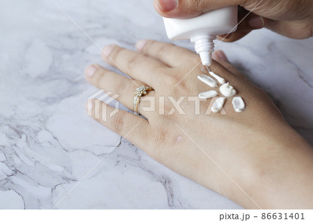 women apply sunscreen cream on hand women apply sunscreen cream on hand 86631401
