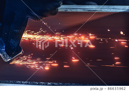 Closeup of Sparks that fly out when grinding metal details machine. Metallurgical Plant 86635962