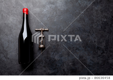 Red wine bottle and vintage corkscrew 86636458