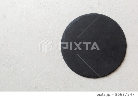 top view of empty black slate plate on cement background. Empty space for your design 86637547