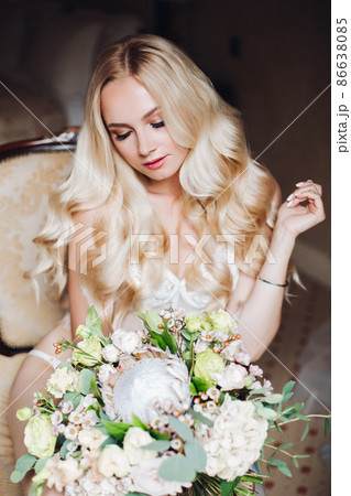 Pretty bride holding wedding bouquet and posing Pretty bride holding wedding bouquet and posing 86638085