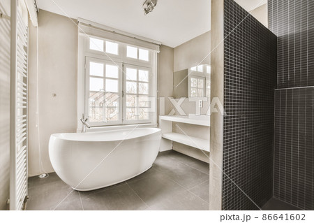 Stunning bathroom design with black shower cabin and modern bathtub Stunning bathroom design with black shower cabin and modern bathtub 86641602