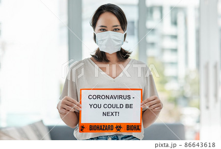 No one is exempt. Shot of a woman holding up a sign saying CORONAVIRUS - YOU COULD BE NEXT. No one is exempt. Shot of a woman holding up a sign saying CORONAVIRUS - YOU COULD BE NEXT. 86643618
