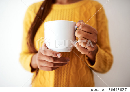 As long as I have coffee, Im good. Cropped shot of an unrecognizable woman holding a cup of coffee. 86643827
