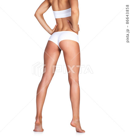 Summer ready legs. Studio shot of an unrecognizable young woman in her underwear posing against a white background. Summer ready legs. Studio shot of an unrecognizable young woman in her underwear posing against a white background. 86643858