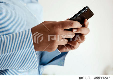Never underestimate the power to connect. Cropped sot of an unrecognisable businesswoman using a smartphone. 86644287