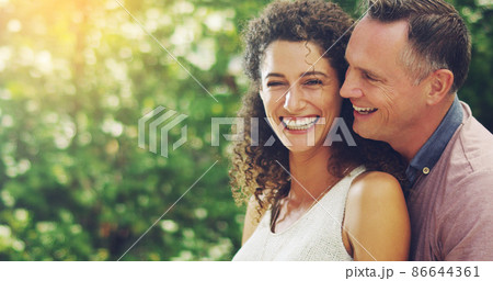 Love brightens the whole world. Portrait of a happy and affectionate mature couple spending quality time together outdoors. 86644361