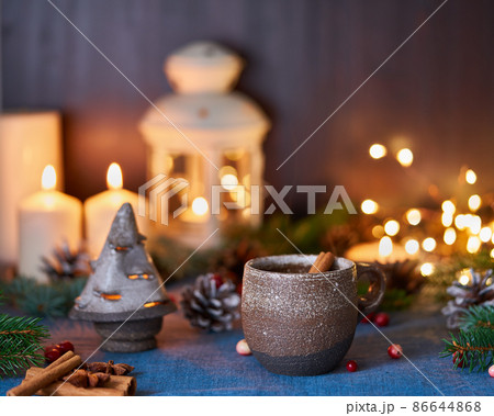 Cup of hot drink on christmas background. Cozy evening, mug of mulled wine Cup of hot drink on christmas background. Cozy evening, mug of mulled wine 86644868