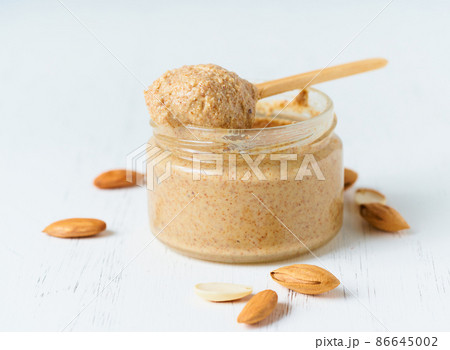 Almond butter, raw food paste made from grinding almonds into nut butter, crunchy and stir 86645002
