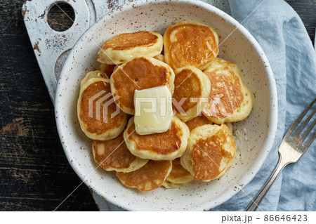 Pancakes cereal, tiny thin funny crumpet, children's food. Breakfast with drink, dark table Pancakes cereal, tiny thin funny crumpet, children's food. Breakfast with drink, dark table 86646423