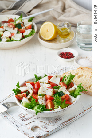 Salad with squid, cucumbers, tomatoes, lettuce. LCHF, FODMAP, paleo diet. Salad with squid, cucumbers, tomatoes, lettuce. LCHF, FODMAP, paleo diet. 86646479