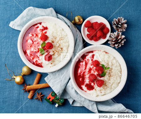 Rice pudding. Christmas food. French milk rice dessert with raspberries. Dark background. 86646705