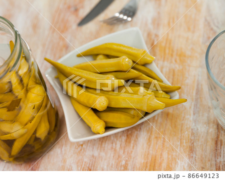 Pickled okra pods on plate, homemade preserves Pickled okra pods on plate, homemade preserves 86649123